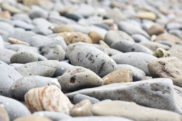 Rocks of many colors and sizes by the sea soft focus.