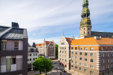 Obraz premium Tourism in Europe. Old town of Riga, Latvia. Modern and traditional architecture. St. Peter's Church.