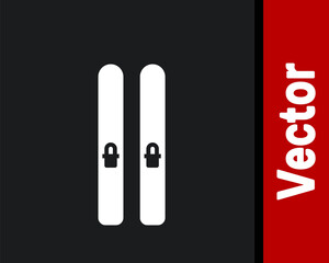 White Ski and sticks icon isolated on black background. Extreme sport. Skiing equipment. Winter sports icon. Vector Illustration.