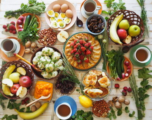 Soft focus or blurry focus.Photo above.A lot of wholesome vegetarian food on the table, ready to receive guests. Healthy homemade food.