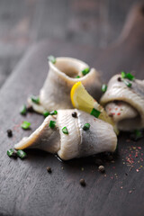Naklejka premium classic marinated herring rolls with chives and lemon