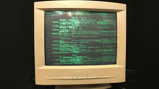 Hacking an old vintage TV or computer monitor screen 80s 90s style. Green code on screen monitor. Abstract source code data flow. screen noise. Old kinescope