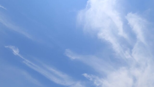 Slow motion TimeLapse of beautiful white cirrus or cirrostratus cloud & silky soft cloudscape moving on sunny clear blue sky background in tropical summer or spring sunlight at sunshine day, B-roll 