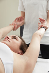 Fototapeta na wymiar Female Enjoying Relaxing Massage In Cosmetology Spa Center