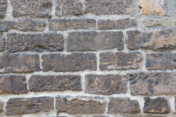 Brick wall of an old building. Ancient brick stone wall texture or background. Masonry or brickwork of antique construct. Abstract texture or background. Close up shot.