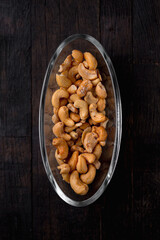 roasted and salted cashews in a glass dish