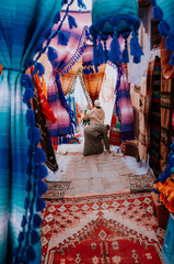 colorful street market in morocco. Sale of textiles on the street