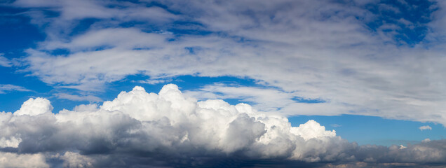 Panoramic View of Puffy White Clouds with Blue Sky during a beautiful Sunny Day. Taken over Vancouver, British Columbia, Canada.