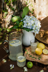 Fresh handmade lemonade on a wooden table in a sunny day outdoors. Still life.