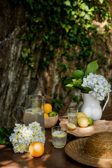 Fresh handmade lemonade on a wooden table in a sunny day outdoors. Still life.