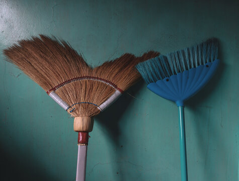 A traditional Filipino broom versus modern broom closely captured.
