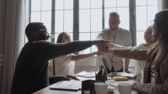 Collaboration Connection Team Brainstorming Unity. workers putting hands together piling on top of one another representing teamwork