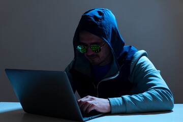 Man programmer or hacker working on laptop