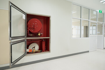 Rescue firefighter equipment, fire line in red box.Fire hose reel in the public building area.Fire...