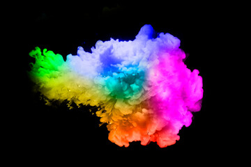 Colorful paint drops from above mixing in water. Ink swirling underwater. on background black