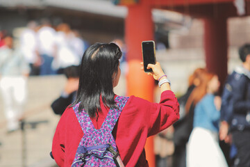 Girl take a selfie at shrine in Japan