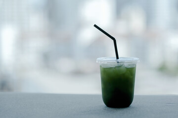 A glass of ice matcha in cafe