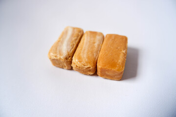 
A side view of three nut snacks on a white background