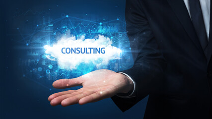 Hand of Businessman holding CONSULTING inscription, successful business concept