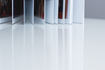 Pages of an open book reflected on a table