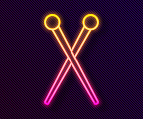 Glowing neon line Knitting needles icon isolated on black background. Label for hand made, knitting or tailor shop. Vector Illustration.