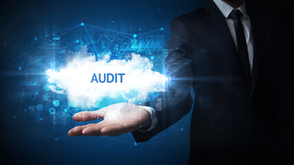 Hand of Businessman holding AUDIT inscription, successful business concept