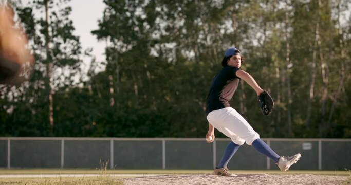 Perfect fastball pitch. Baseball pitcher throws a hard pitch. Heat down the plate from a young pitcher. Shot in 4k.