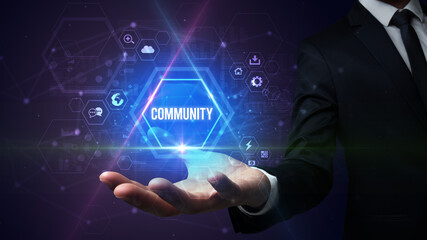 Man hand holding COMMUNITY inscription, social media concept