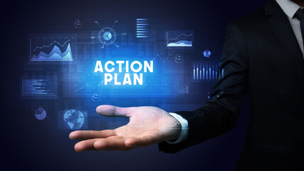 Hand of Businessman holding ACTION PLAN inscription, business success concept