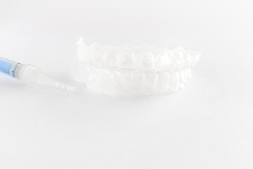 Fototapeta na wymiar Teeth tray for dental whitening opalescence and bleaching gel syringe