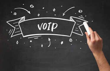 Hand drawing VOIP abbreviation with white chalk on blackboard
