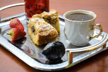 Cake with juice and coffee on a tray. Sweet Breakfast early in the morning