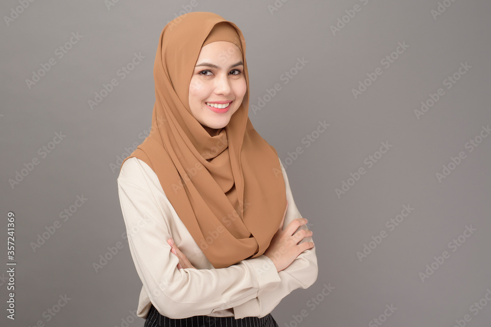 Wall mural Portrait of beautiful woman with hijab is smiling on gray background