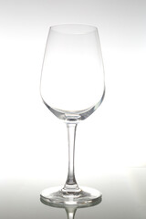 Empty wine glass on glass table. Empty glass on white background.