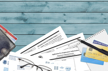 USCIS form I-765 Application for employment authorization lies on flat lay office table and ready...