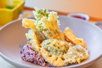 Close-up on Japanese dishes of battered and deep fried assortment of vegetables tempura of lotus...
