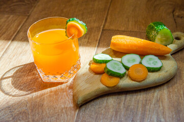 Carrot juice. Healthy food, healthy drink. Cucumbers and carrots. Seasonal vegetables. Orange juice...