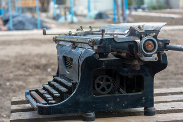 Retro typewriter, old typewriter close-up, side view.