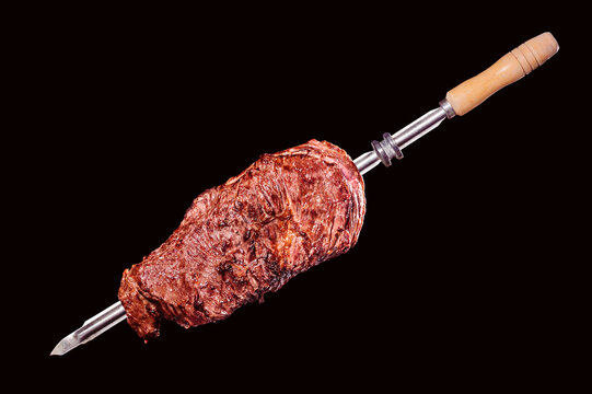 A brazilian traditional barbecue grilled flank steak on the stick - Fraldinha no espeto