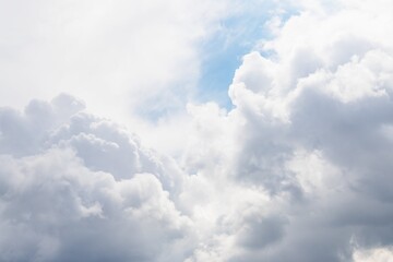 Gray and white fluffy clouds in the pale sky. Beautiful sky