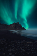 Beautiful View of Mountains in Iceland with Nordic Northern Lights and oceanside view