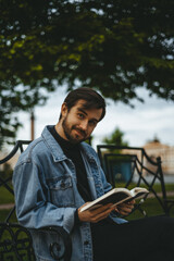Fototapeta premium man reading a book in the park