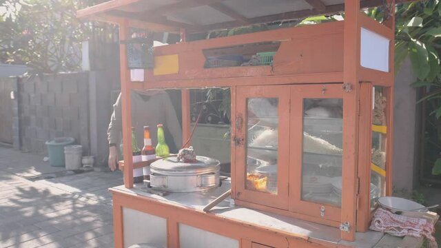 man selling bakso in the carts. indonesia street food vendor. small business entrepreneur