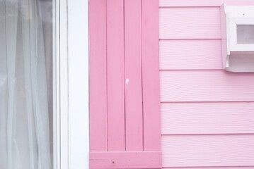 A colorful wooden house looks from the side