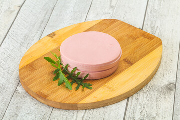 Sliced sausage over the wooden board