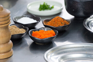 pots with seasonings and fish eggs