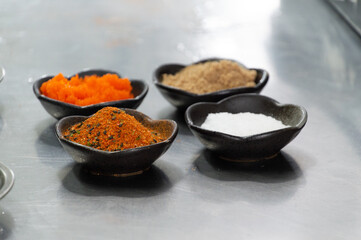 pots with seasonings and fish eggs