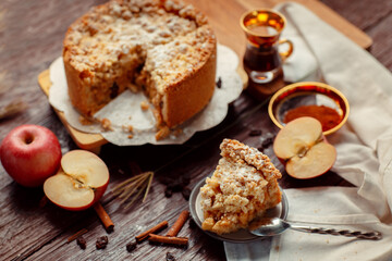 Homemade delicious apple pie with different ingredients on rustic background. Classic autumn Thanksgiving dessert - organic apple pie.