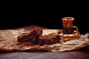 Delicious homemade chocolate brownies on dark background. Chocolate dessert aesthetics