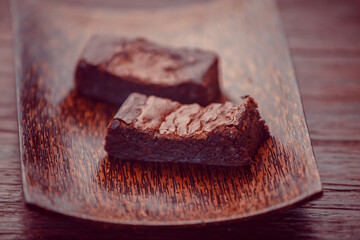 Delicious homemade chocolate brownies on dark background. Chocolate dessert aesthetics